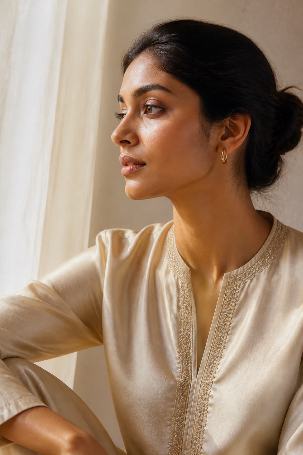 Everyday gold-tone earrings with a cream kurta