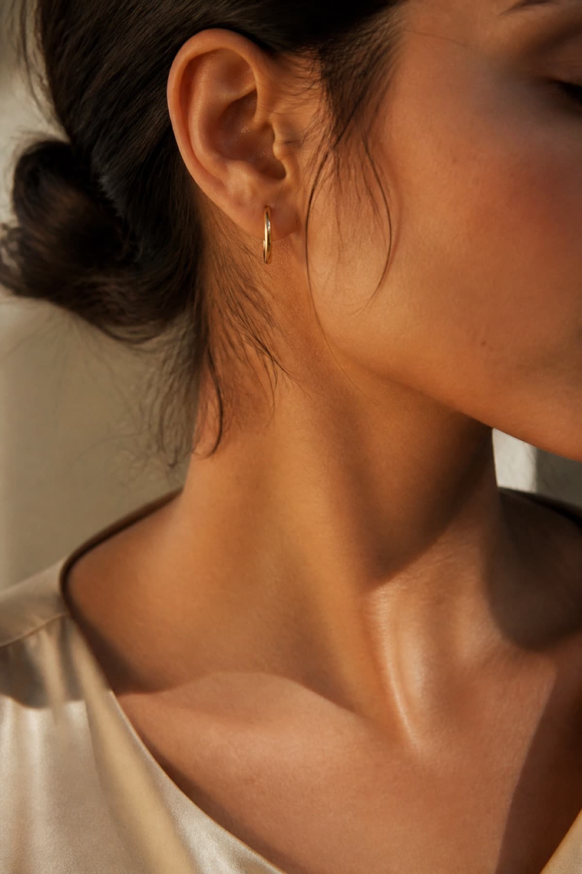 Gold-tone hoop on the ear